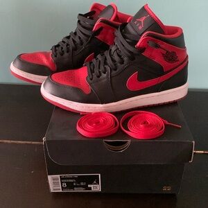 Air Jordan 1 Mid. Size 8. Black laces and red laces. Good condition. With box.